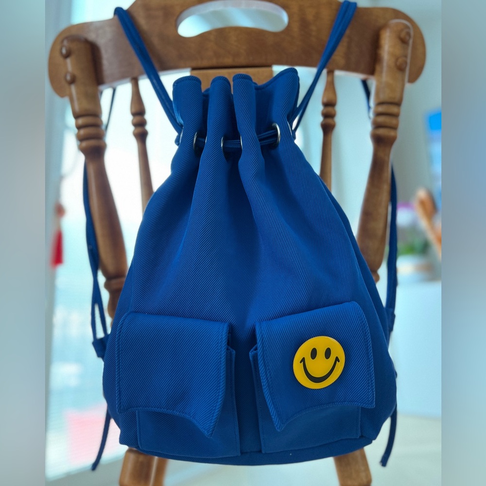 Cute blue backpack in blue colour, including a removable Happy Face pin